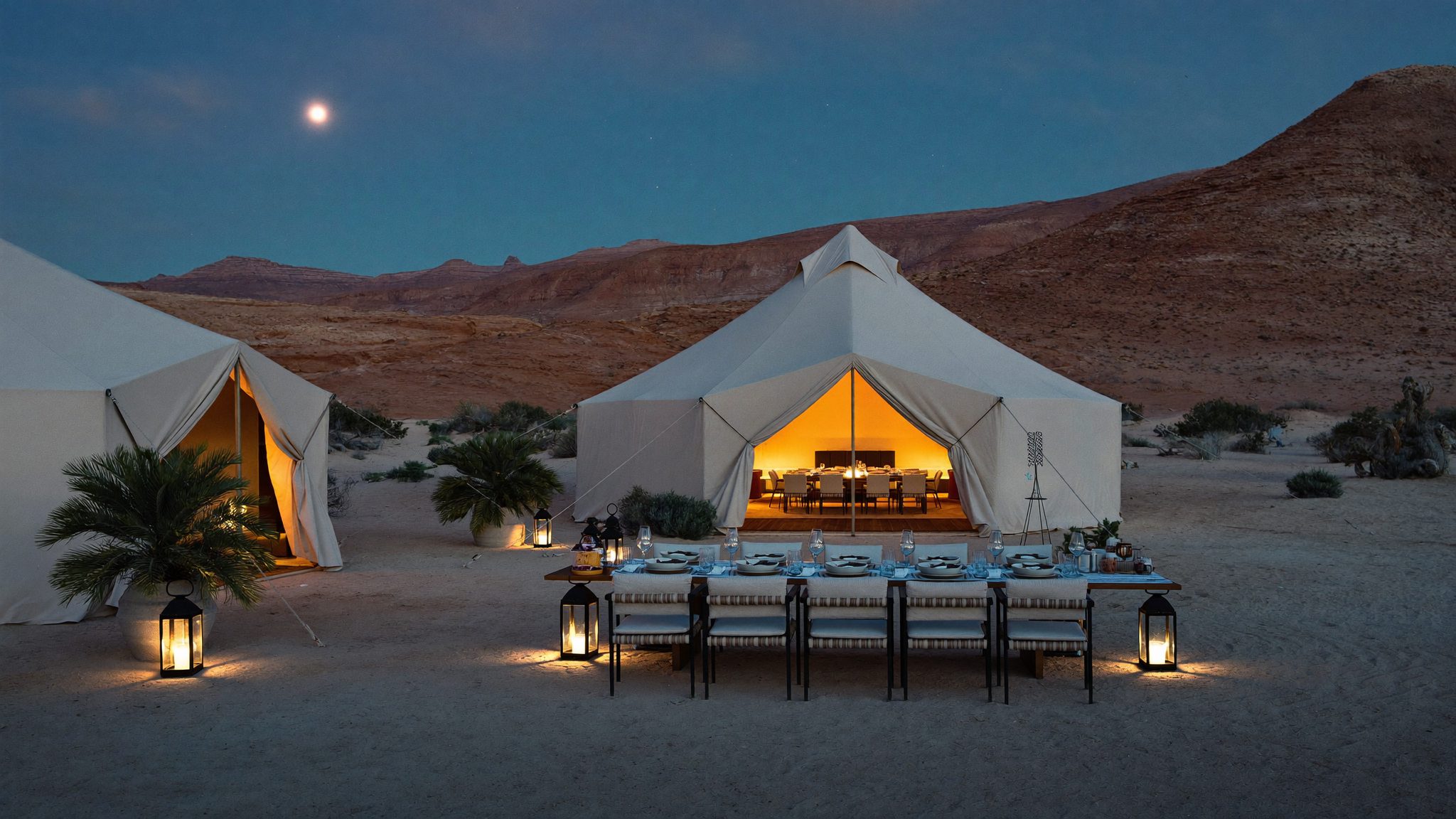 Luxury camp in the Agafay stone desert at dusk, lanterns and moonlight